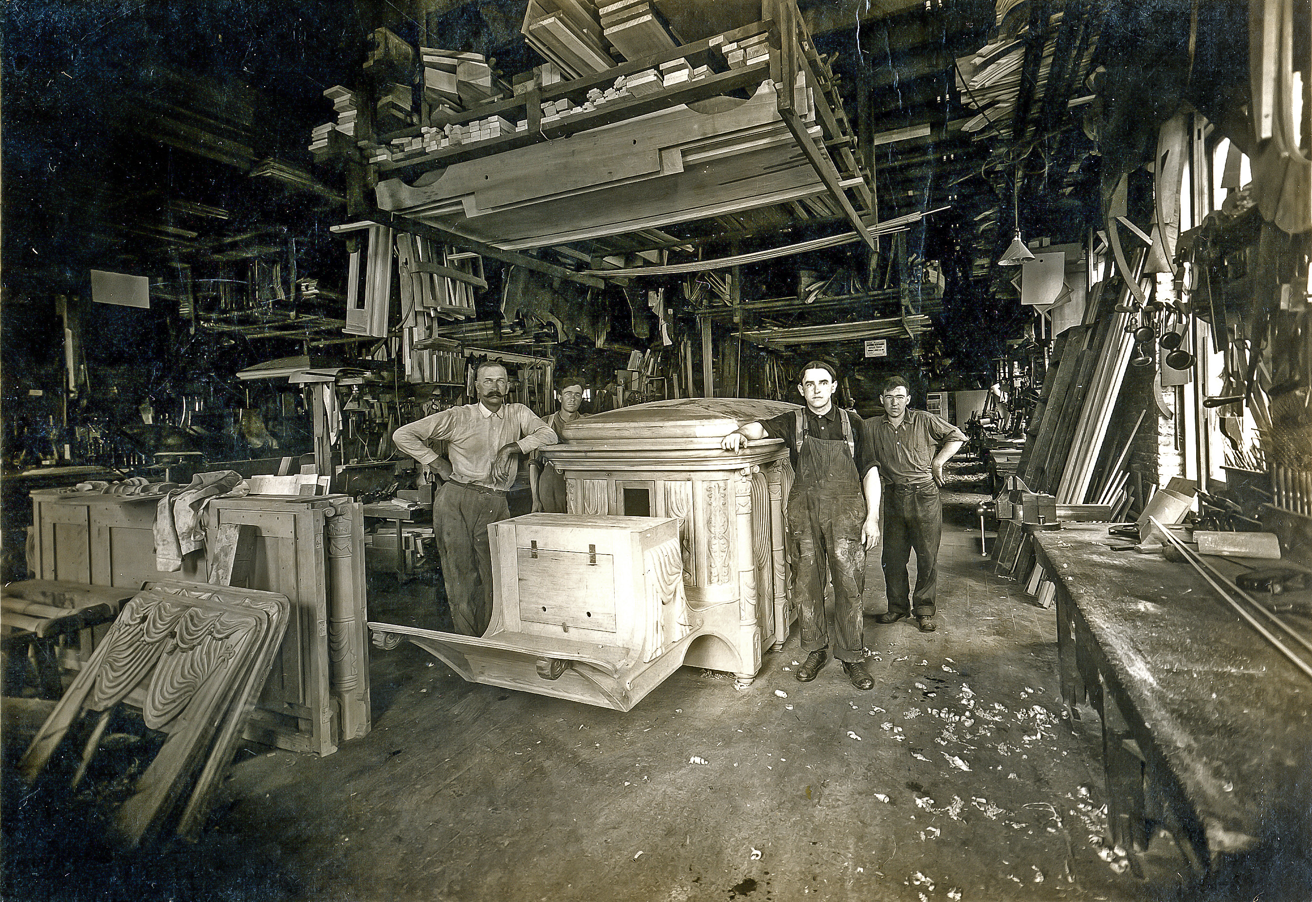 riddle_three_men_posing_with_the_hearse_they_are_building.jpg